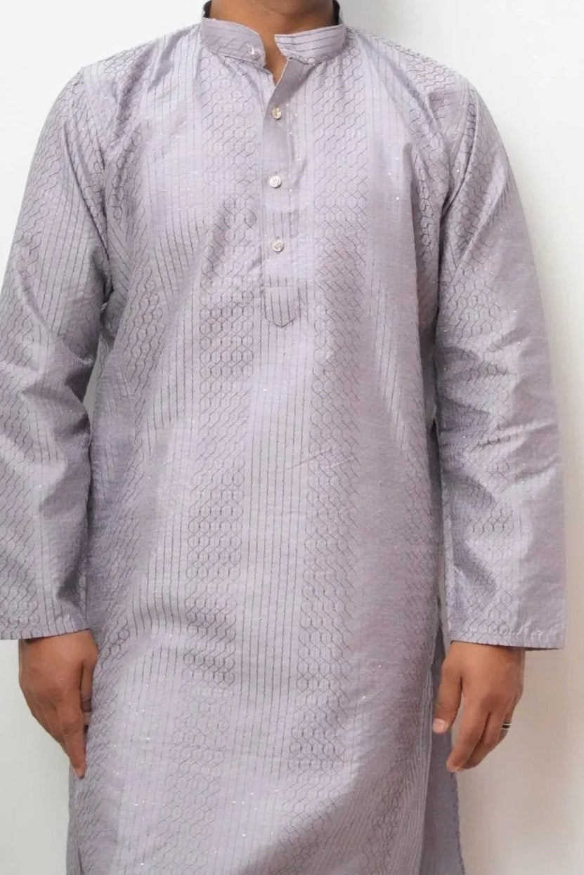 Man wearing a light purple traditional kurta against a white background