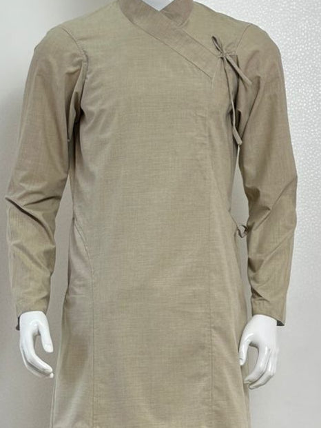 Mannequin wearing a beige traditional Daura Suruwal from nepal with a black cap against a plain background